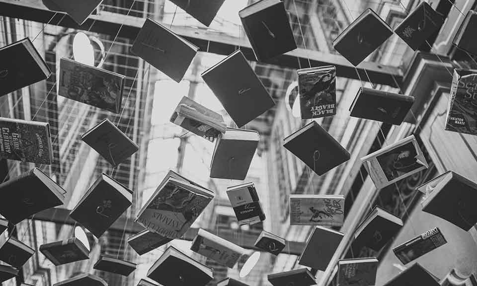 books hanging from strings